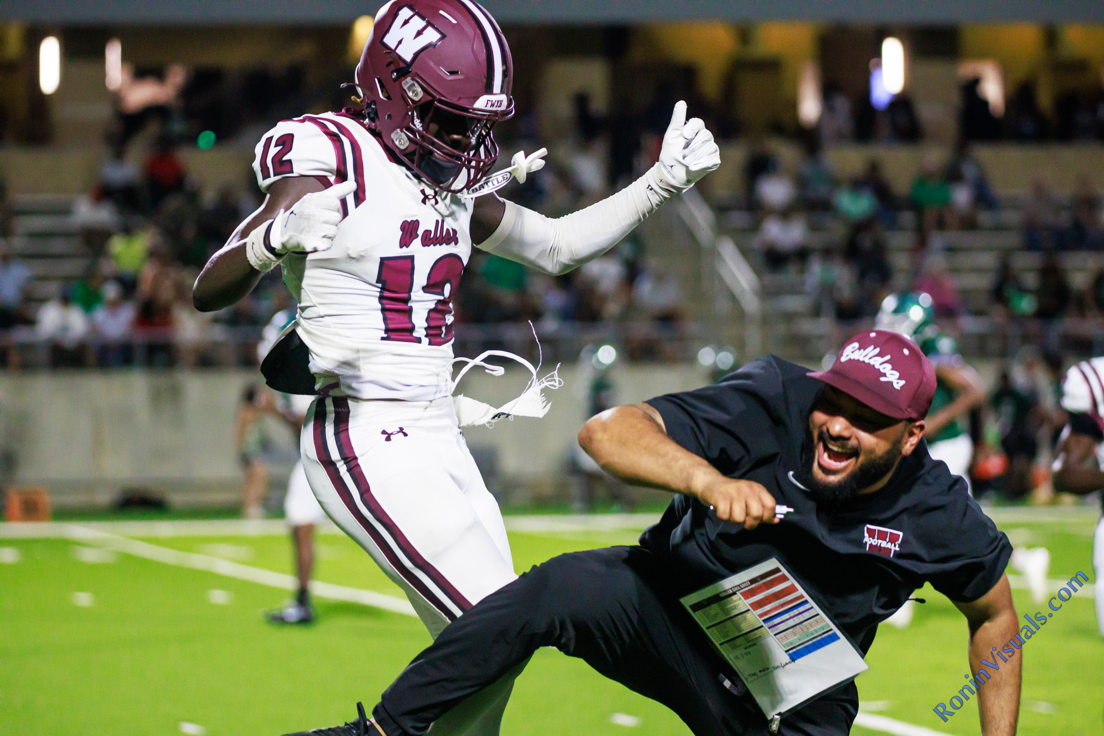 Celebrations included air-chest-bumps after Glowin Mbobile (12) scored a touchdown as the Waller Bulldogs defeat the Spring Lions, 40-0, at Planet Ford Stadium in Spring, Texas, on Friday, Sept. 4, 2026. (Photo by Creighton Holub, © 2026 Ronin Visuals, all rights reserved.)