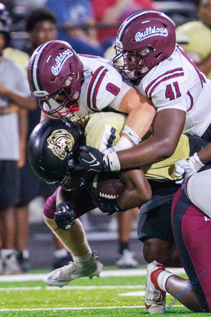 Trace Geigley (8) and Cedric Washington (41) stop a Conroe ball carrier during the third game of the season. (Waller Sentinel photo courtesy Creighton Holub, Ronin Visuals)